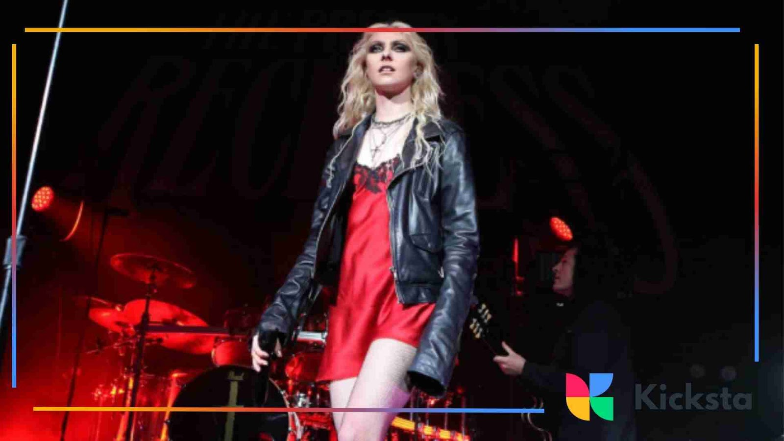 Grunge aesthetic singer performing on stage in red slip dress and black leather jacket.