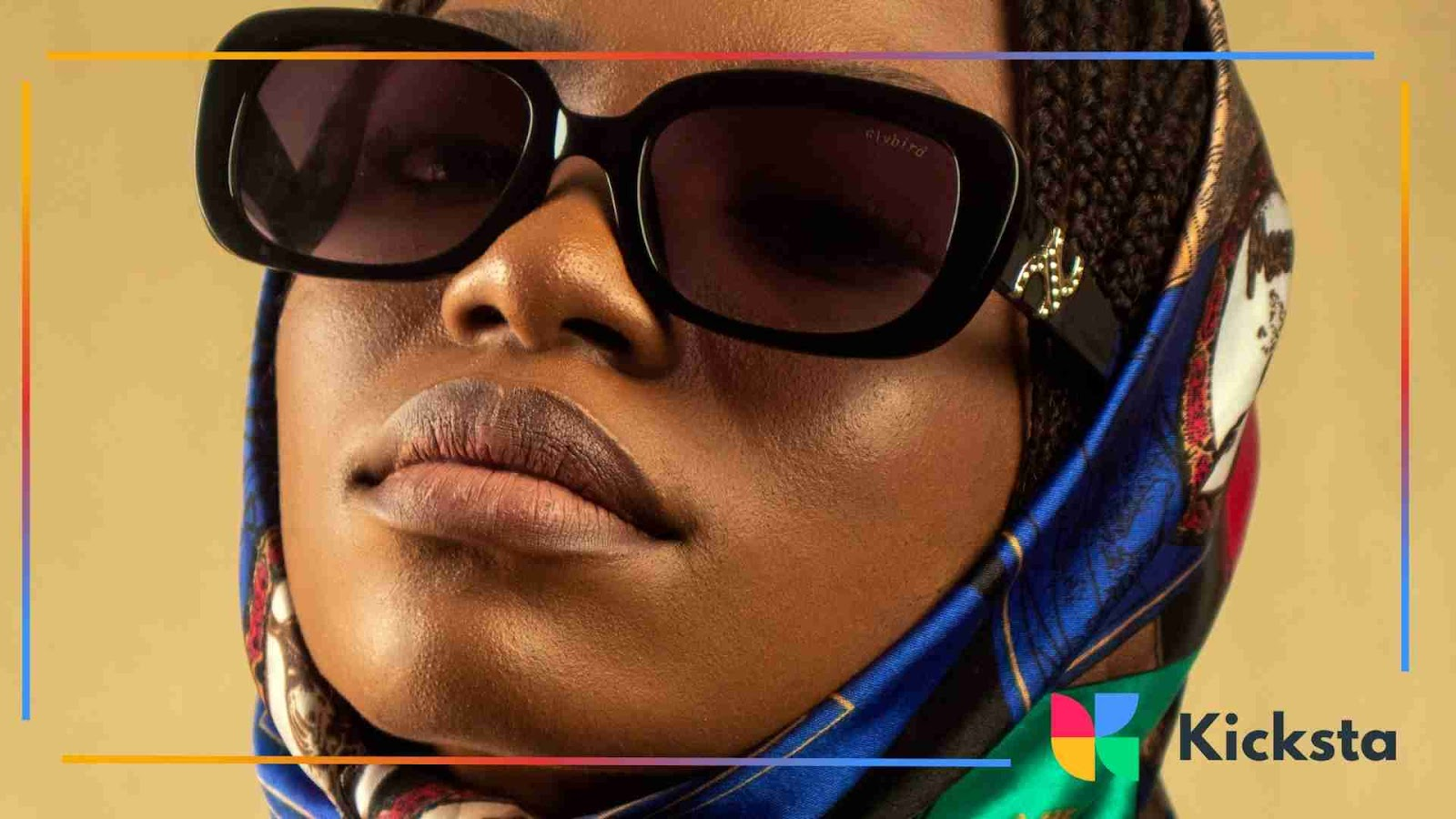 Close-up of woman in oversized sunglasses and silk scarf, showcasing baddie aesthetic style.