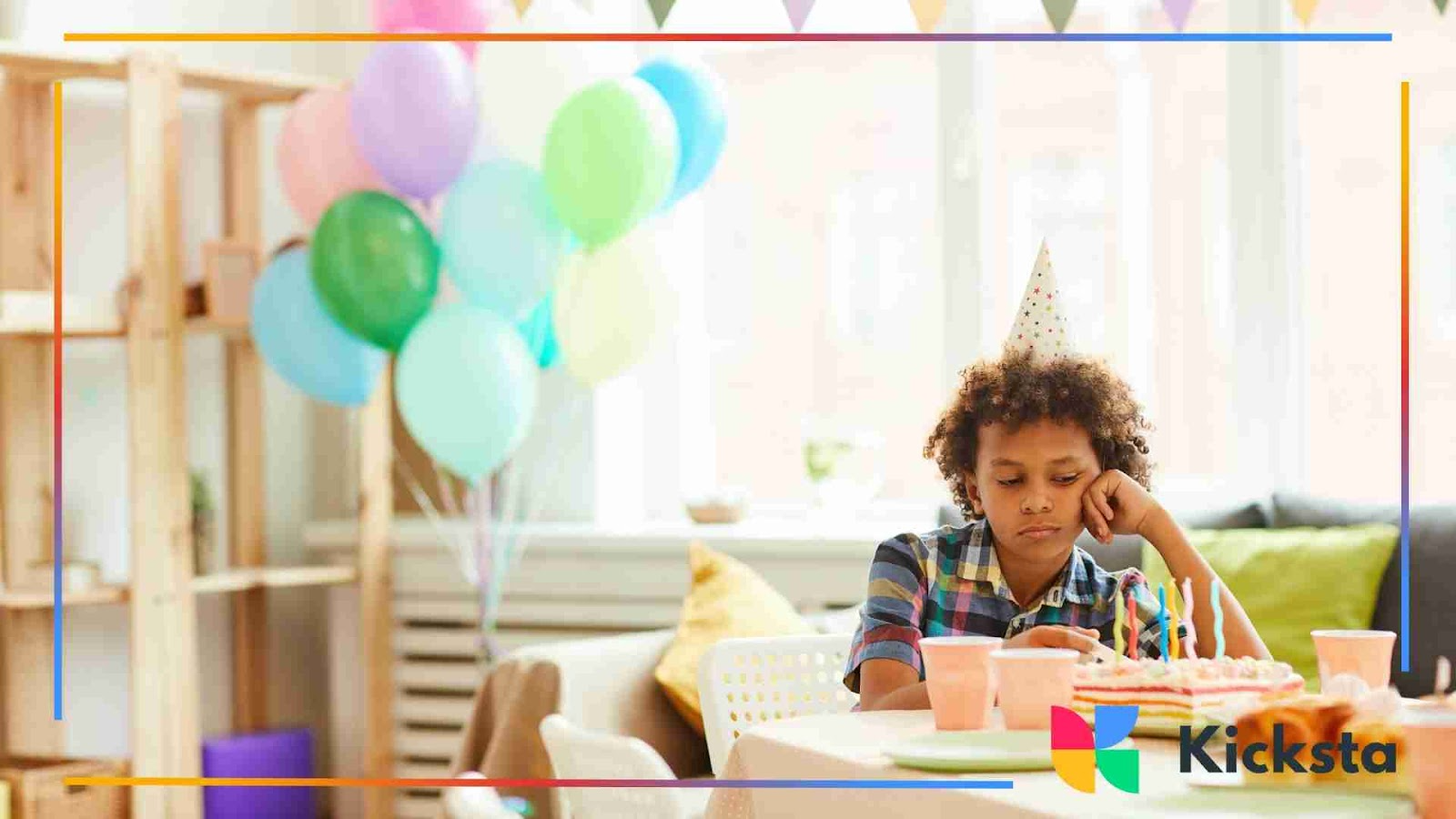 Child at a party with balloons and cake, but looking down and sad