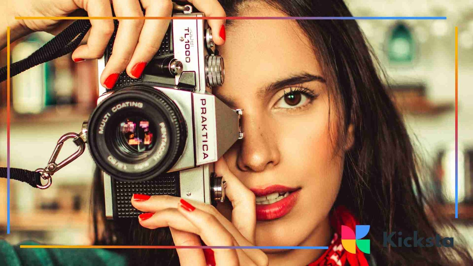 Woman holding a vintage camera close to her face