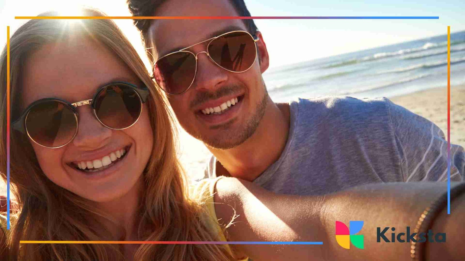 Smiling couple wearing sunglasses at the beach