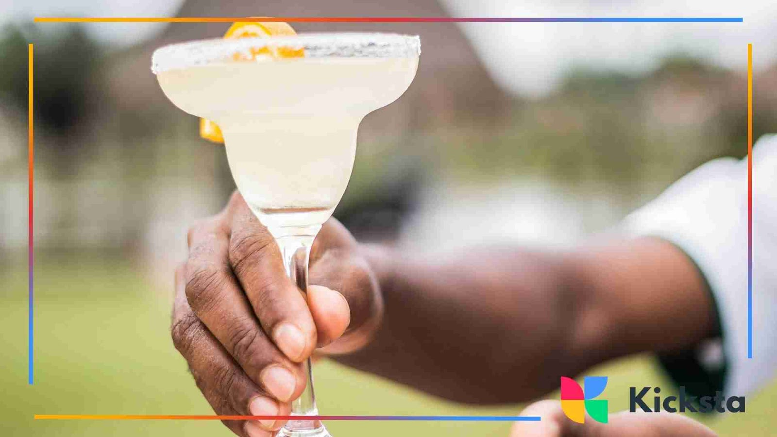 Classy hand holding a margarita glass with a sugared rim