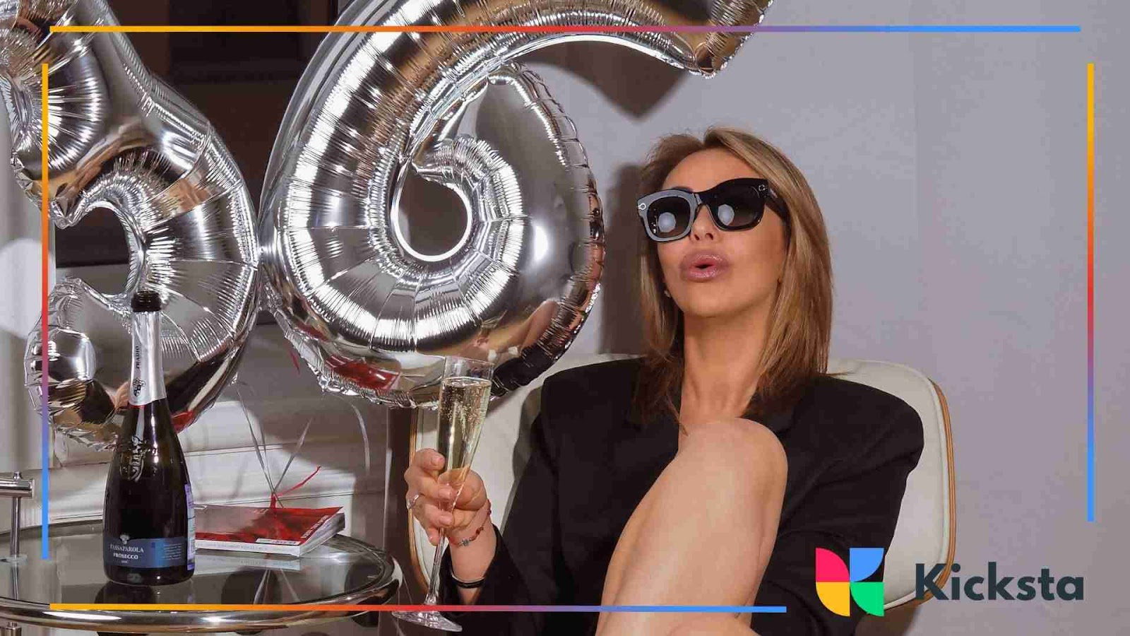 Classy woman celebrating with champagne and oversized silver balloons