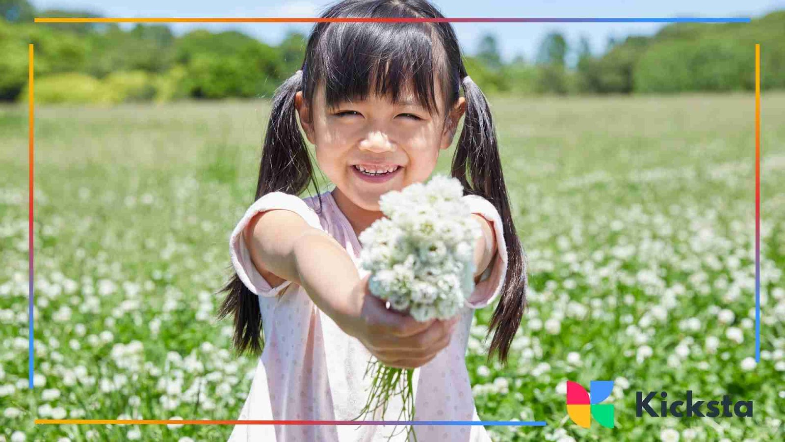 Smiling girl holding out a bunch of white flowers