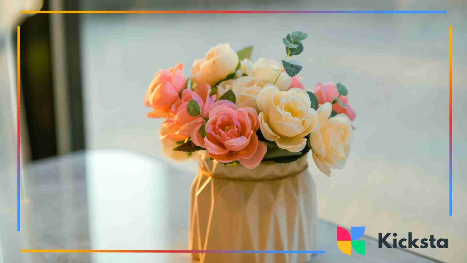Vase of pastel pink and cream roses on a table
