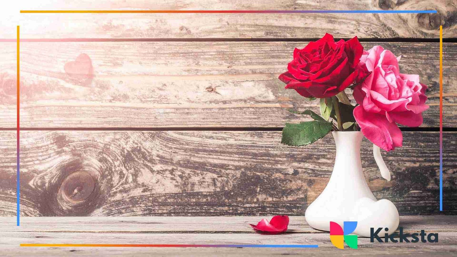 Red and pink roses in a small white vase by wood background