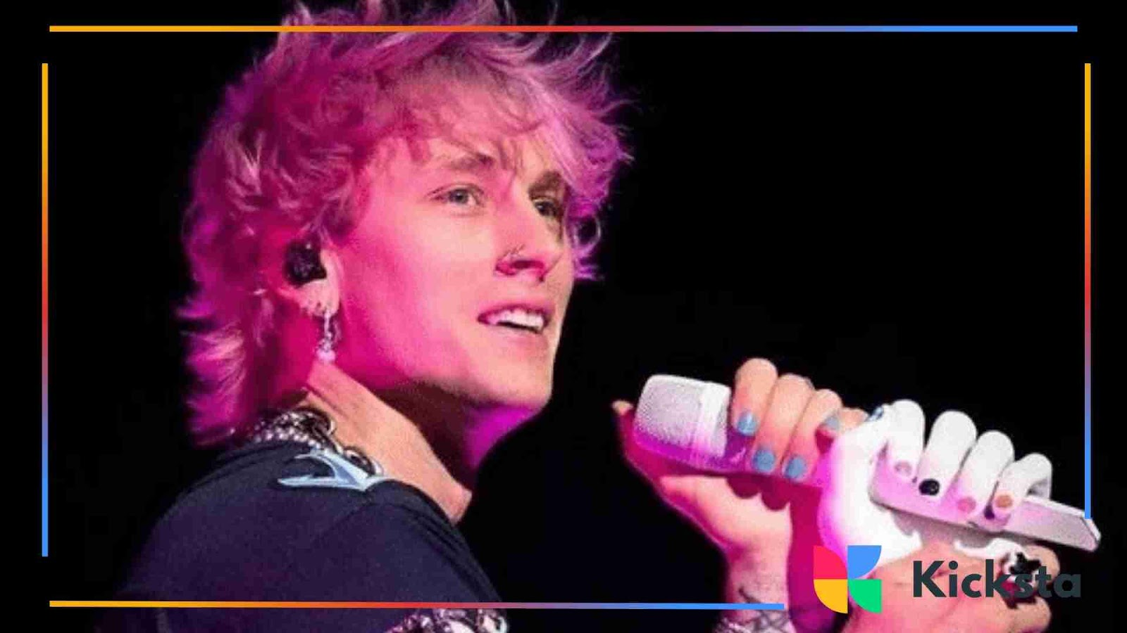Musician holding a microphone on stage, with colorful lighting and painted nails.