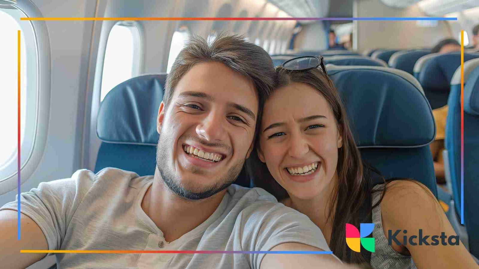 A happy couple smiling and taking a selfie while sitting on an airplane