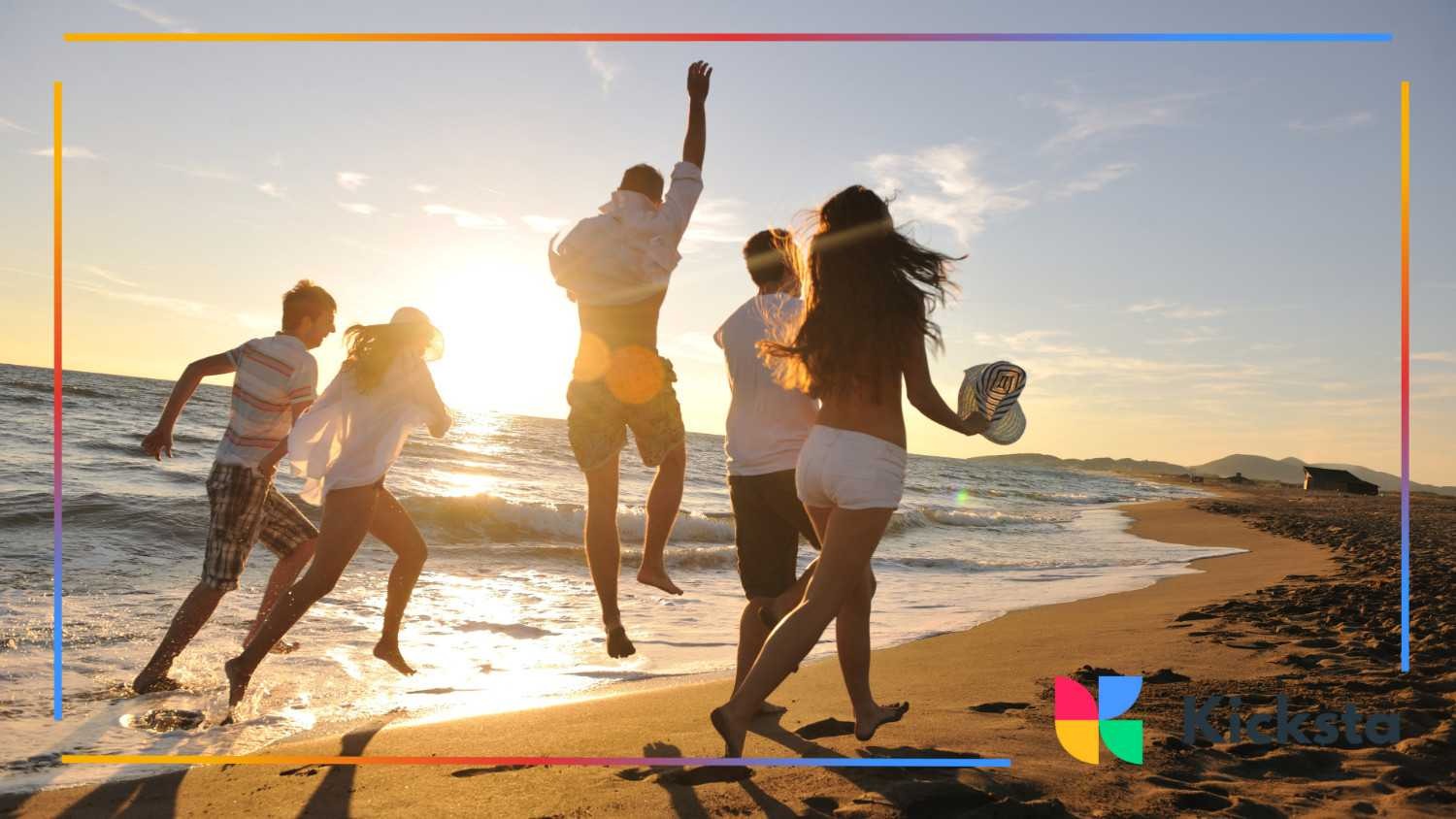 Group of friends running and jumping along the beach at sunset, enjoying the waves and golden light