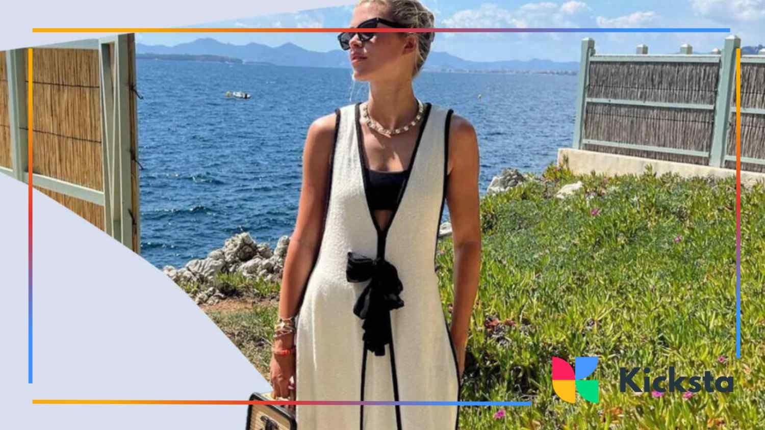 blonde girl with glasses and classy outfit standing on the sea background