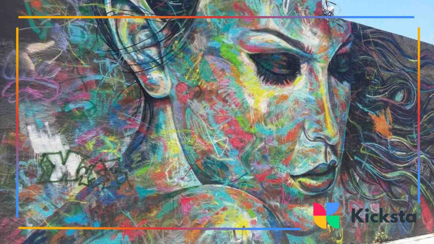 Colorful street mural depicting a detailed portrait of a woman’s face with expressive brushstrokes and abstract patterns.