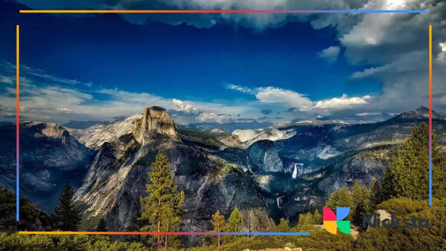 Scenic mountain landscape in Yosemite National Park with rocky peaks, pine trees, and a blue sky filled with clouds.