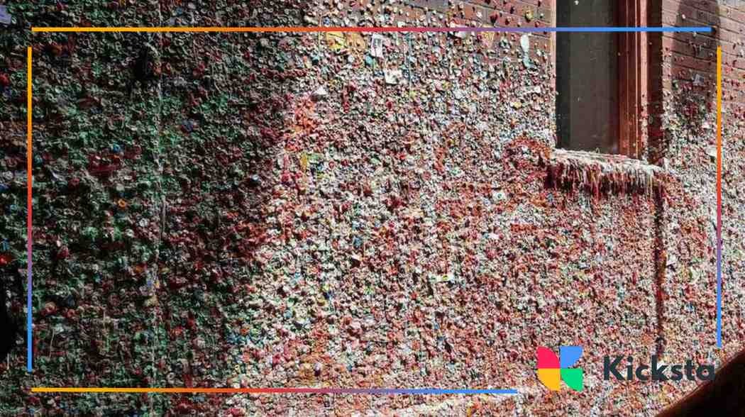 Close-up of the Gum Wall in Seattle covered entirely in colorful chewed gum pieces.