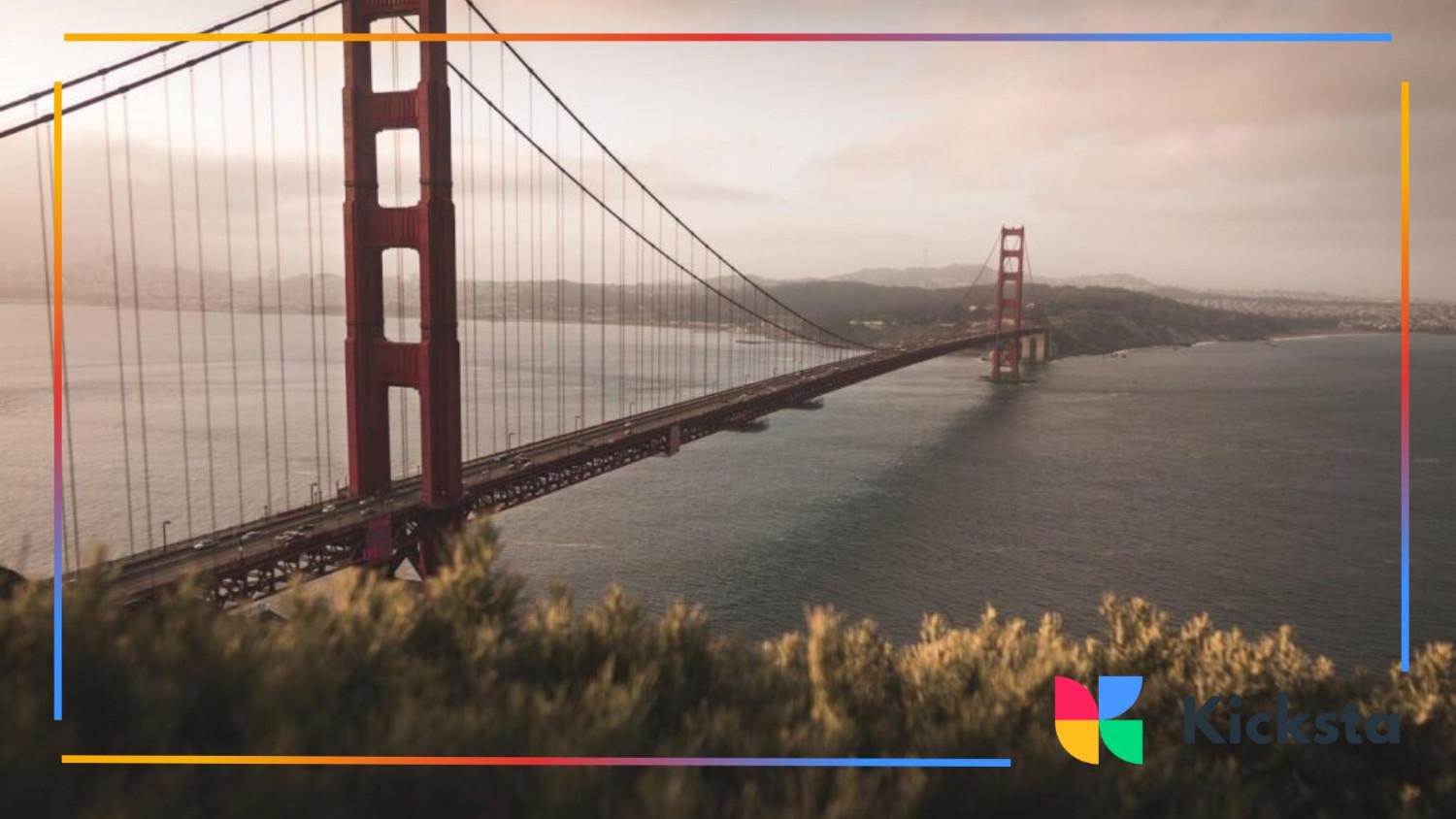 The Golden Gate Bridge spanning over the water on a foggy, overcast day