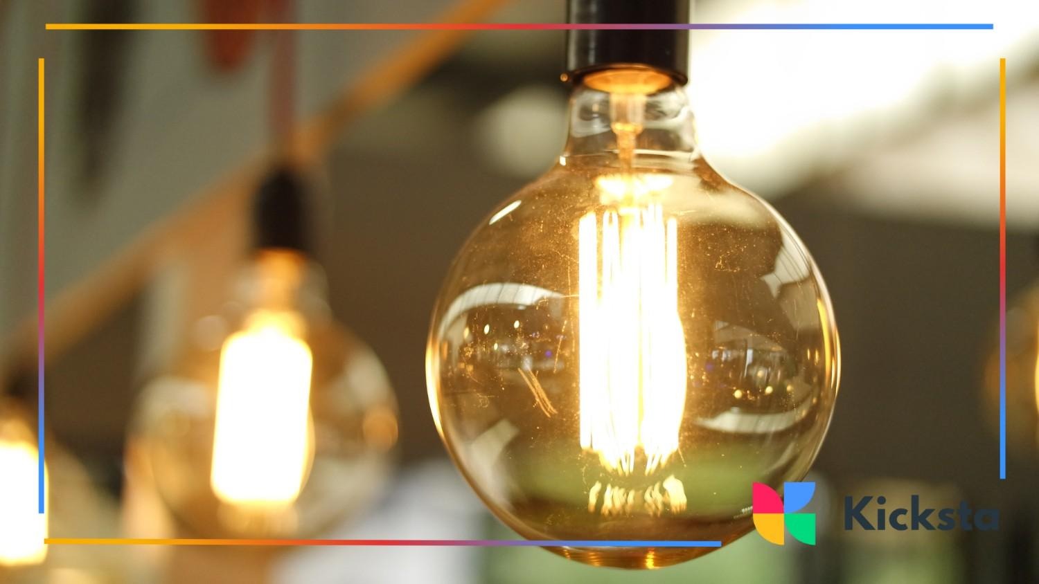 Close-up of a glowing vintage light bulb with warm golden light