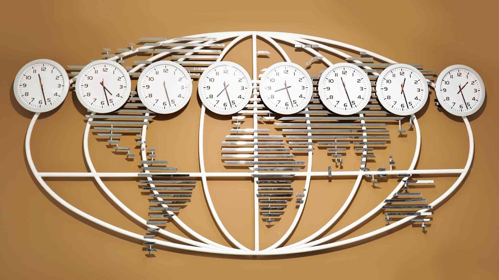 Wall art featuring a world map outline with seven clocks displaying different time zones mounted above it