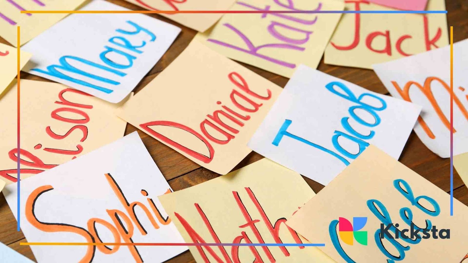 Colorful handwritten name cards scattered on a wooden surface, each with different names written in bold marker, representing personalization or name ideas.