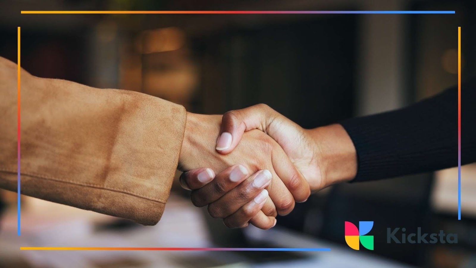 Close-up of two people shaking hands in agreement, symbolizing partnership or collaboration.