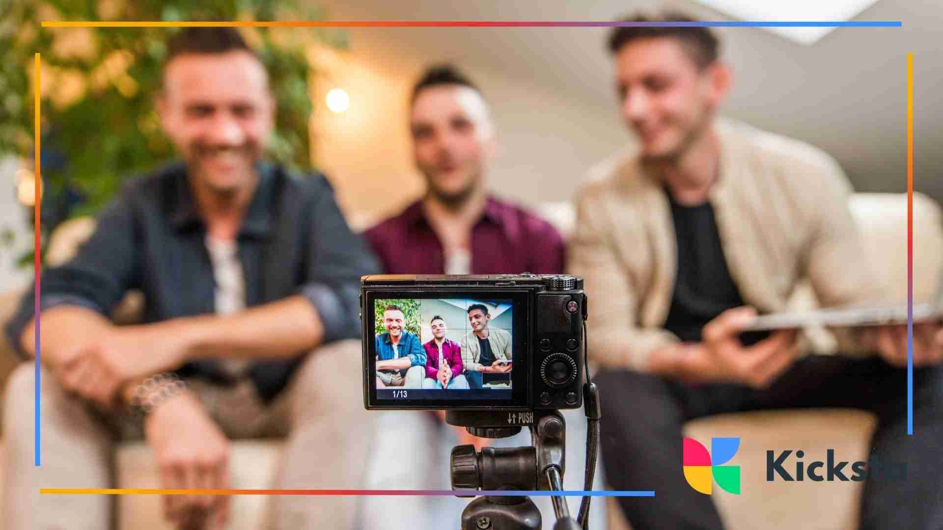 Three people recording a video together with a camera on a tripod.