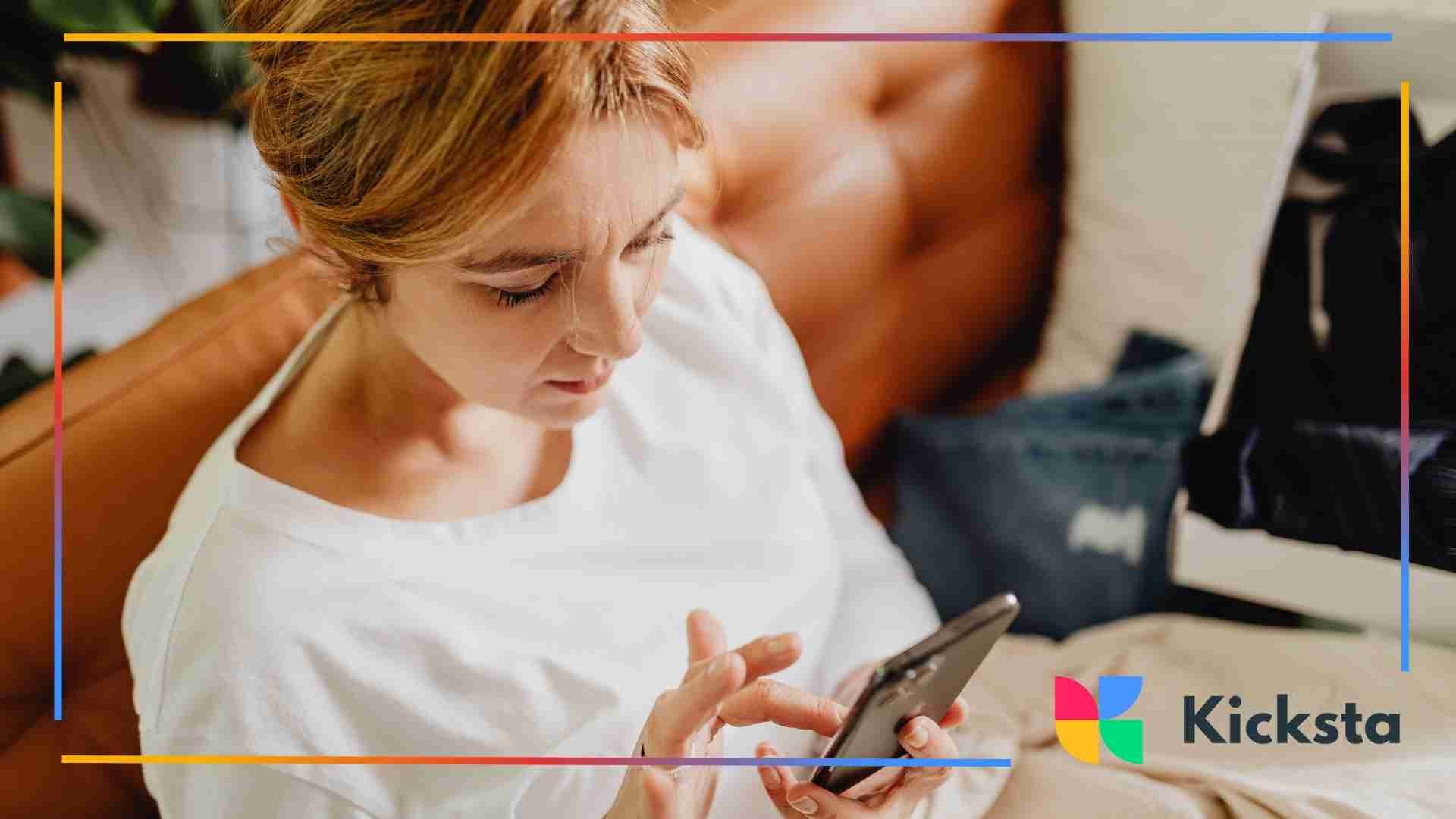 Woman sitting on a couch using her smartphone.