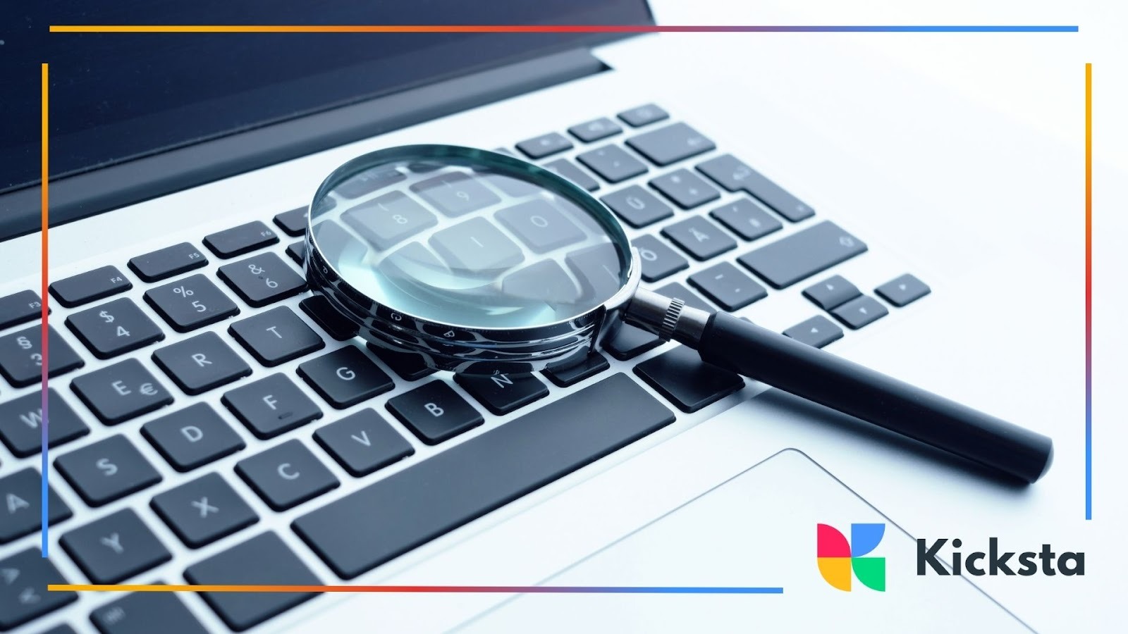 Magnifying glass placed on laptop keyboard symbolizing online search, SEO strategy, and digital research.