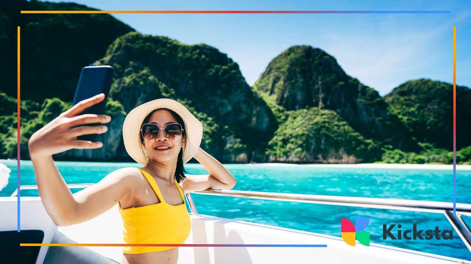 Travel influencer taking selfie on boat in tropical paradise with turquoise ocean and limestone cliffs in background.