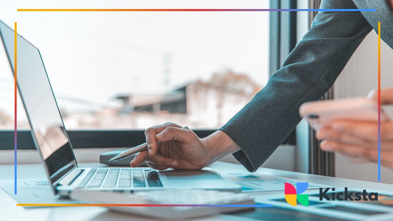 Business professional using laptop and smartphone for digital marketing, social media management, and online strategy planning.