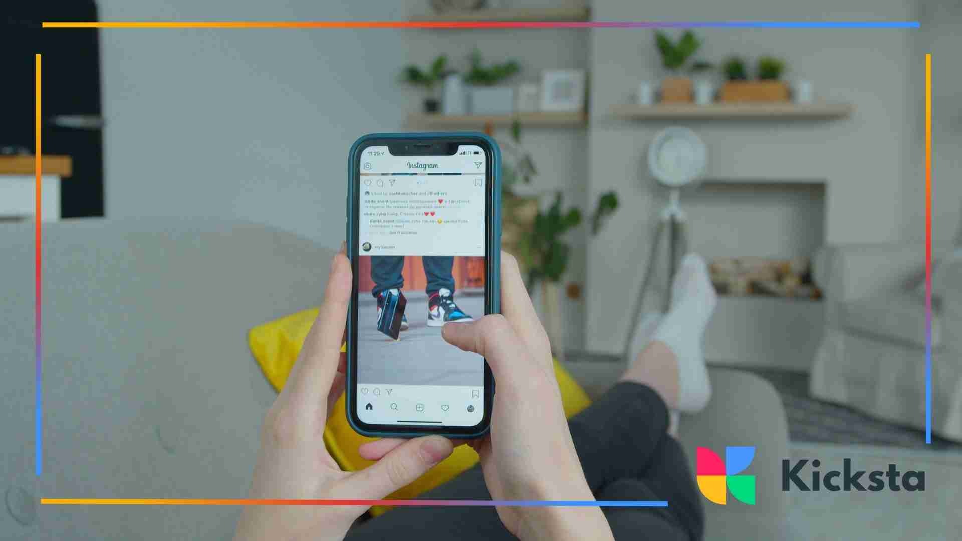 A person relaxing on a couch while scrolling through Instagram on a smartphone in a cozy living room.