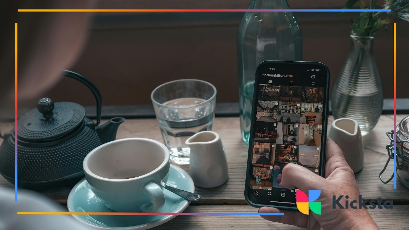 Person using smartphone to browse Instagram feed at café table with coffee and tea, representing social media engagement and digital lifestyle.