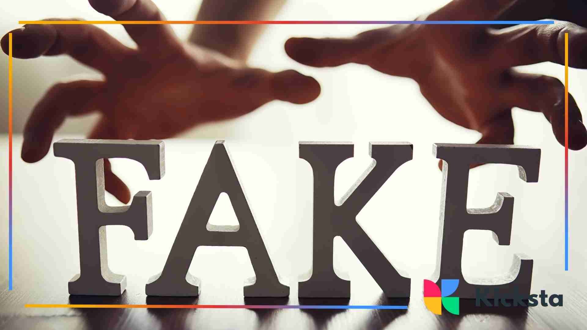 Word Fake on the brown table, hands getting closure to the letters