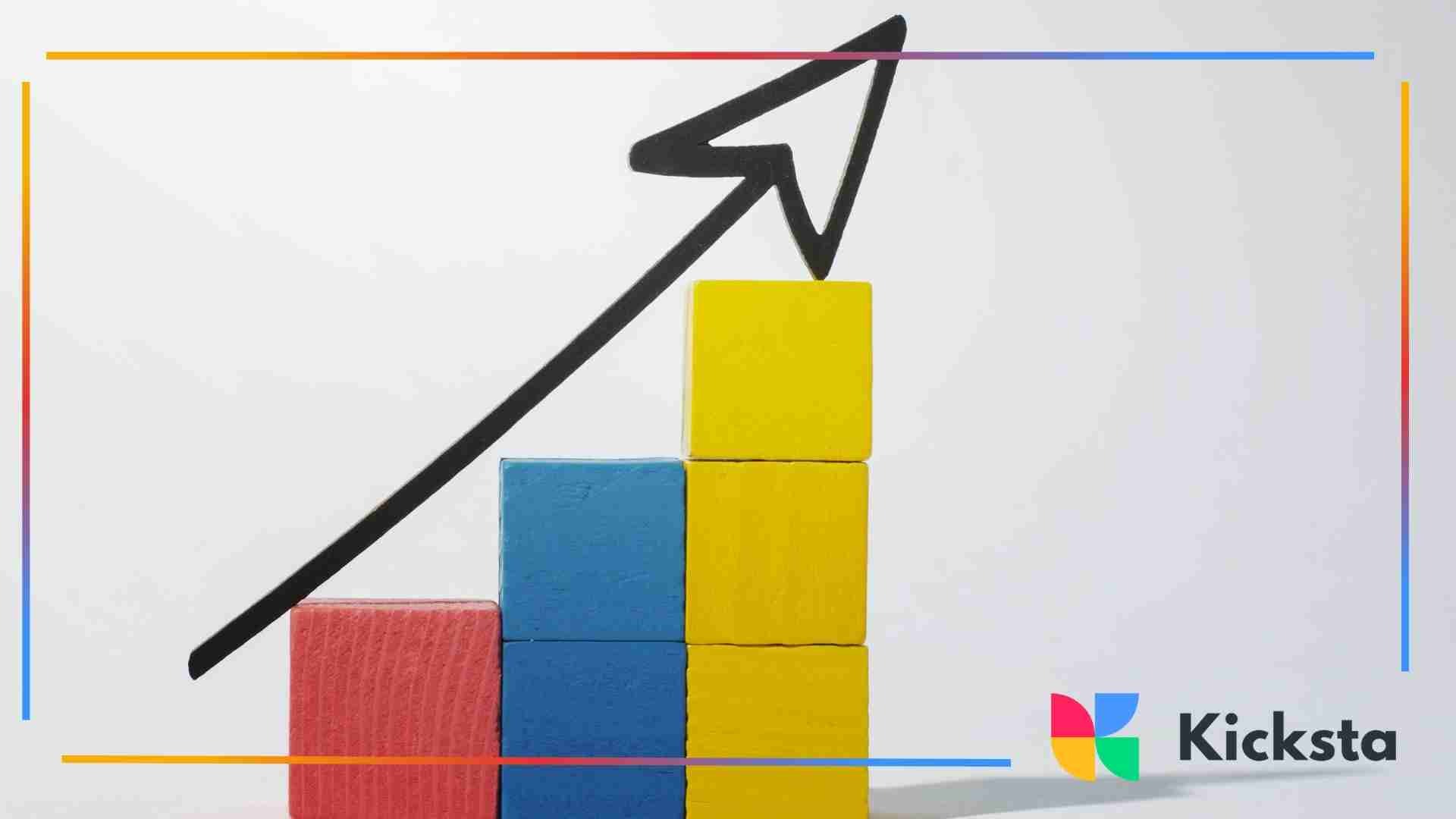 Colorful wooden blocks arranged in ascending order with a black upward arrow drawn above them, symbolizing growth and progress.