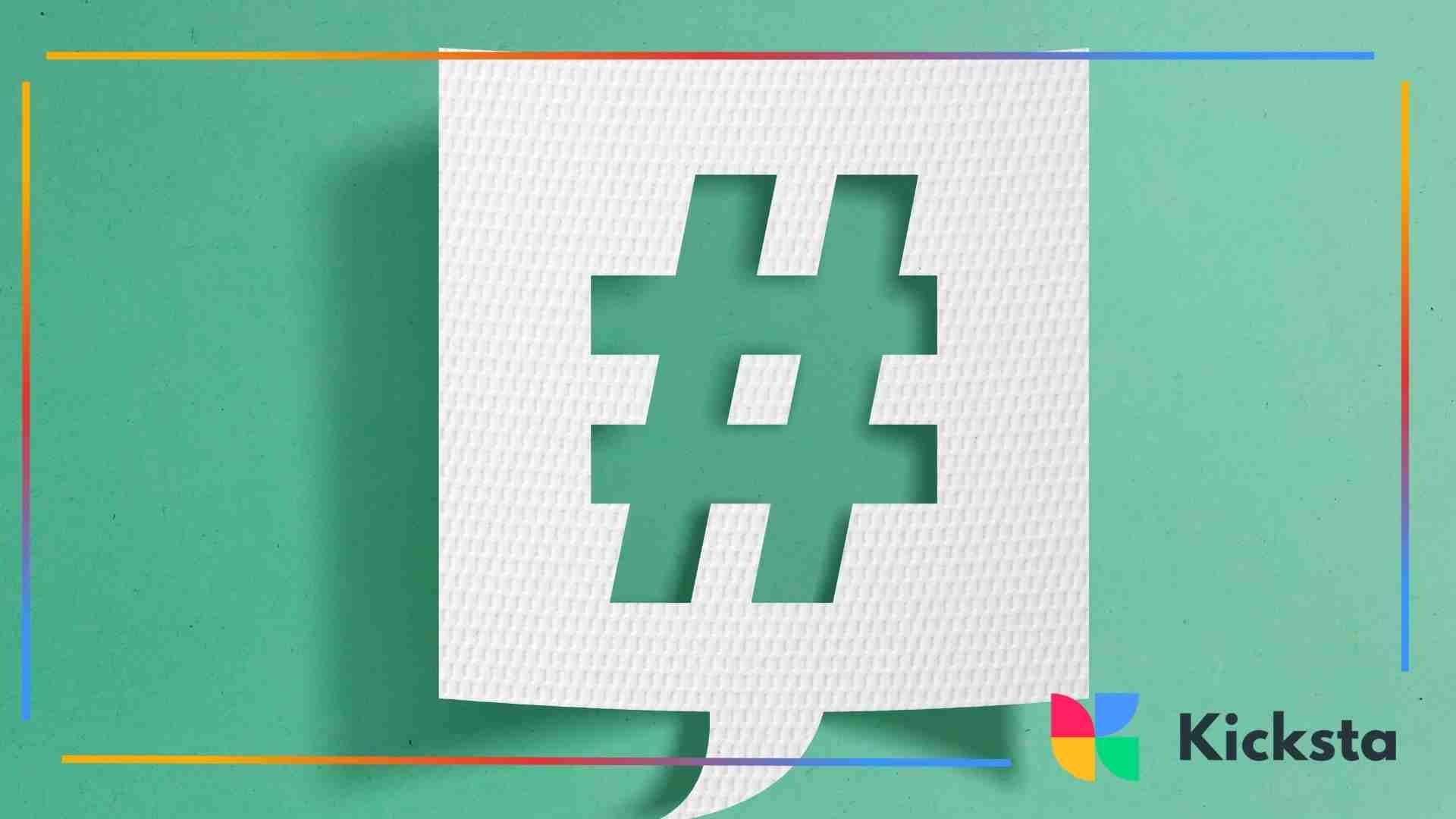 A white paper speech-bubble cutout with a hashtag symbol in the center, placed on a textured green background.