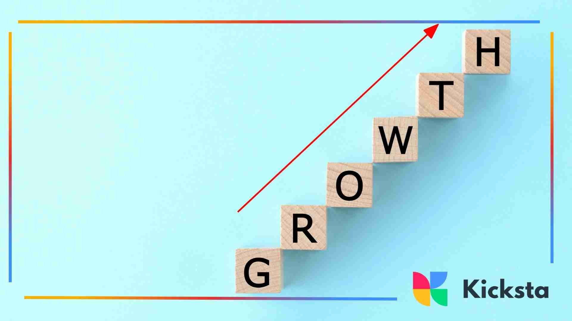 Wooden blocks arranged in a staircase spelling the word “GROWTH” with a red upward arrow above them.