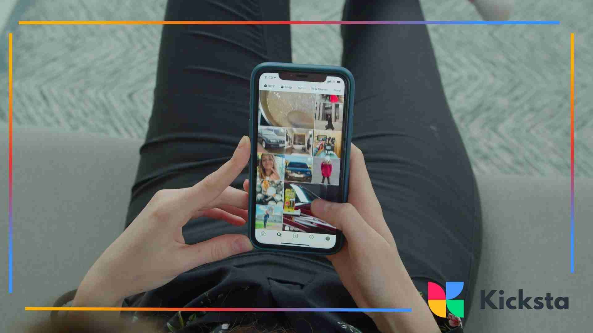 erson holding a smartphone while scrolling through an Instagram photo grid feed.