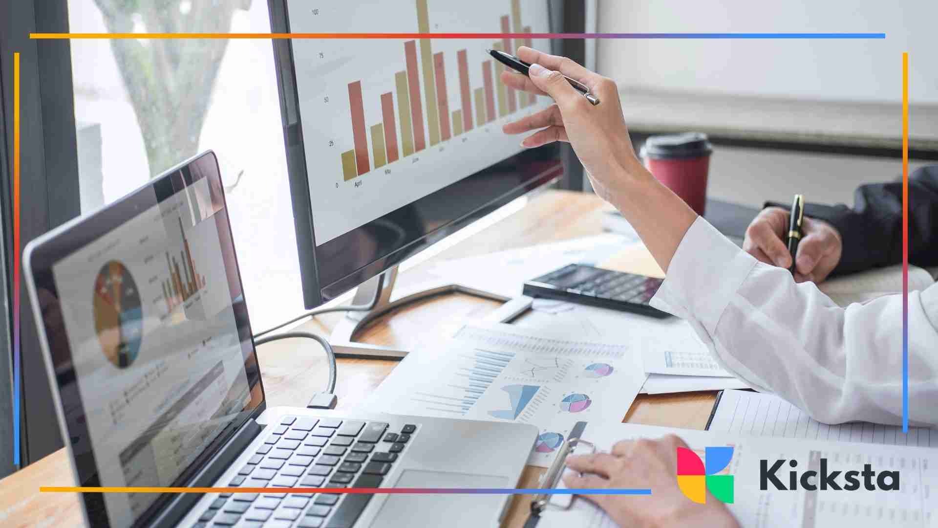 People reviewing business charts and graphs on computer screens during a data analysis meeting
