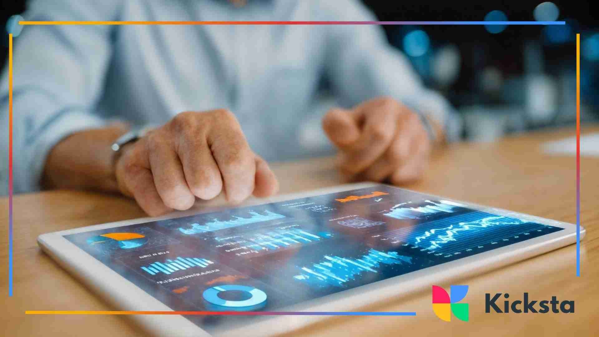 Hands using a tablet displaying analytics charts and data visualizations on a desk