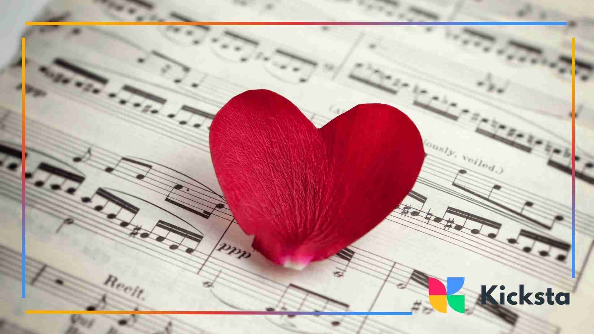 A red rose petal shaped like a heart placed on a sheet of music notes.