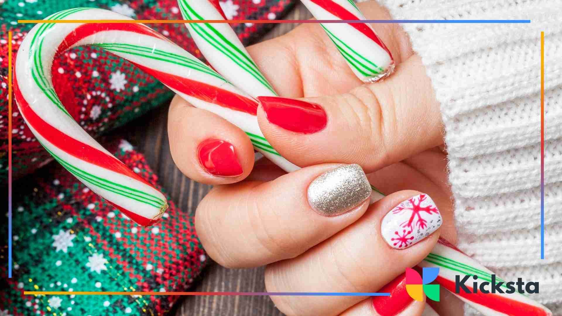 Close-up of hands holding red, white, and green candy canes with festive holiday nail art and cozy winter textures.
