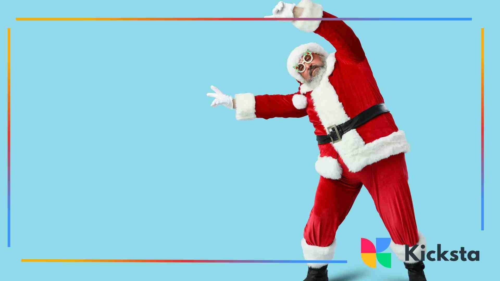 Playful Santa Claus in a red suit striking a fun dance pose against a bright blue background.