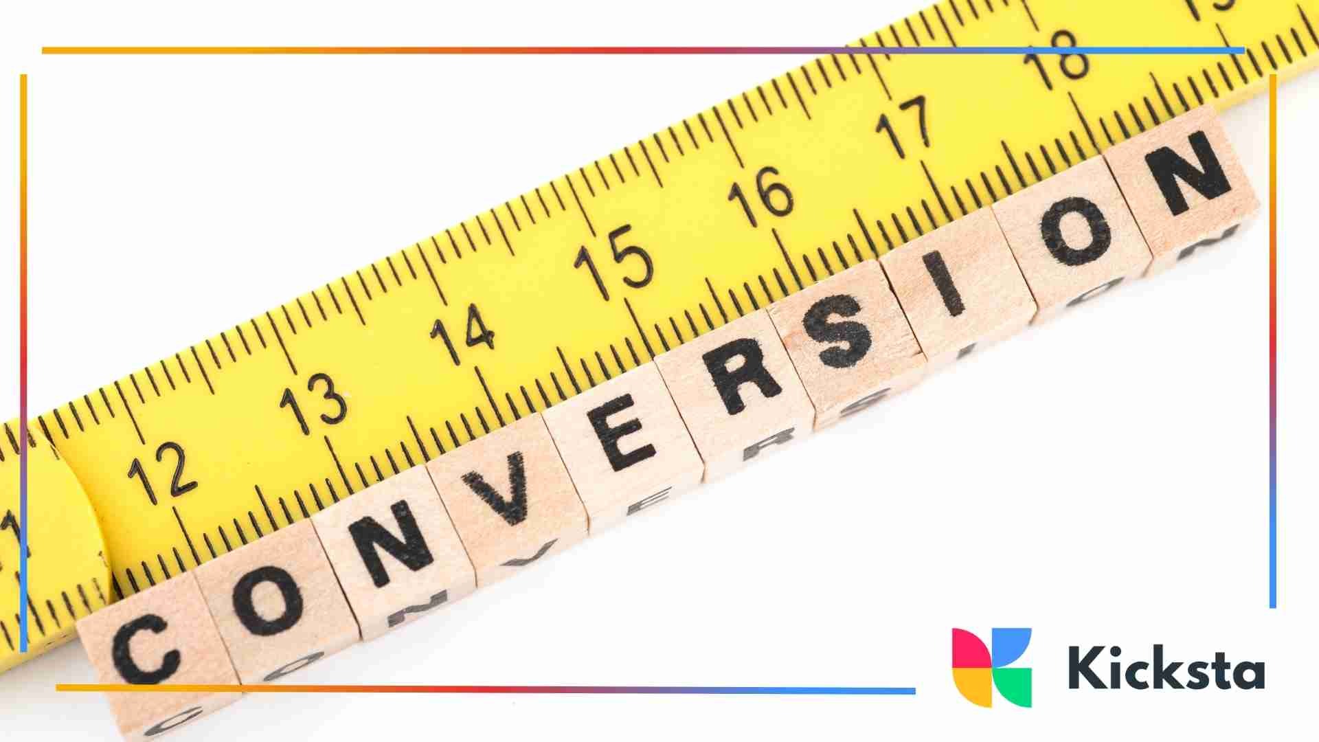 Yellow measuring tape beside wooden blocks spelling “conversion,” symbolizing tracking and performance measurement.