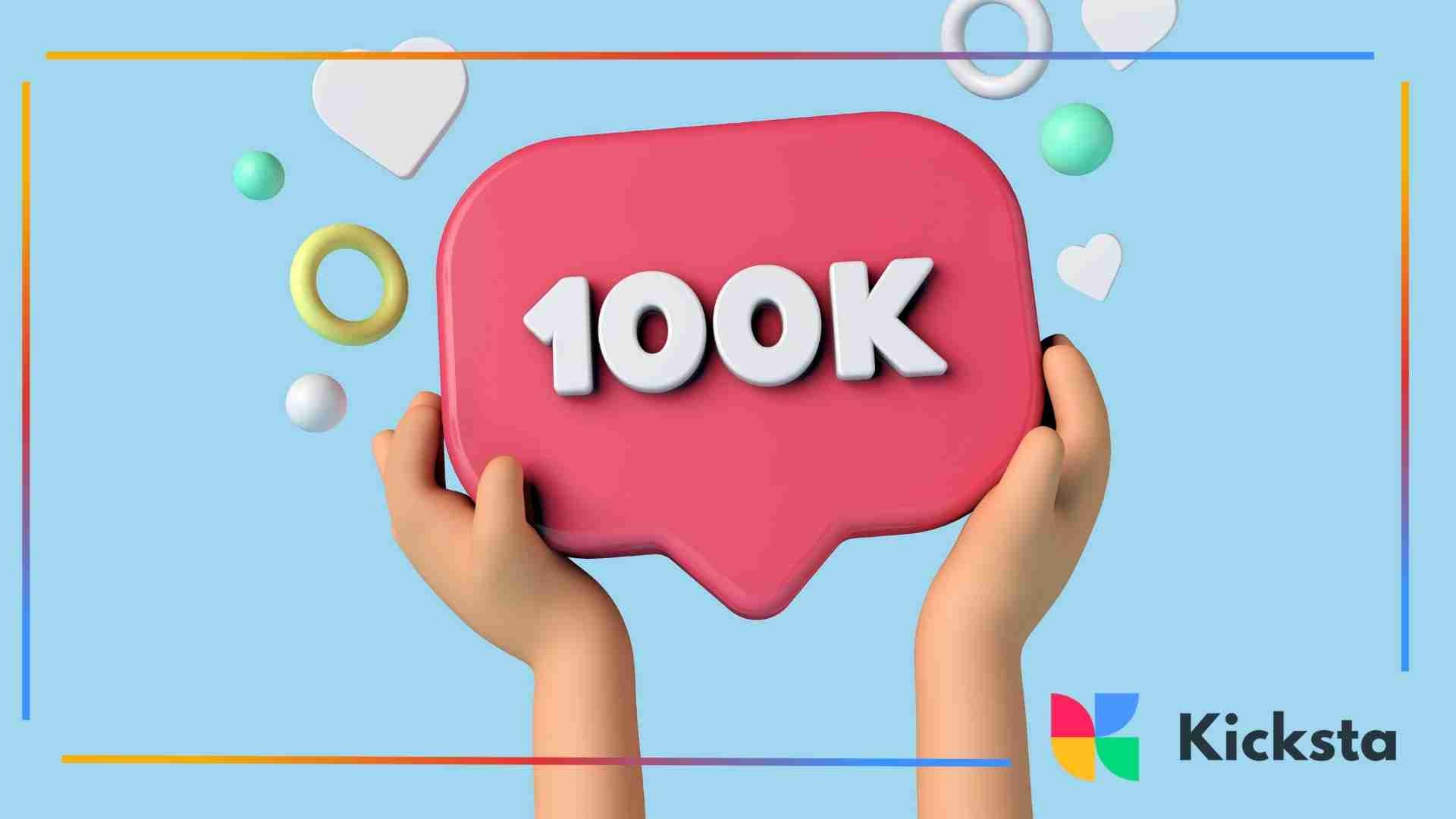 Hands holding a pink social media notification bubble displaying “100K,” representing high follower or like count.