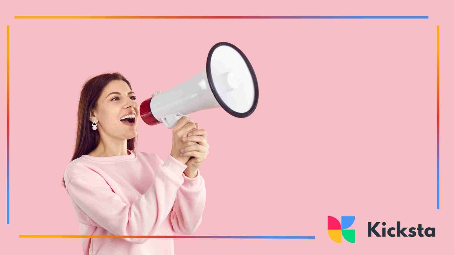 Woman speaking into a megaphone against a pink background