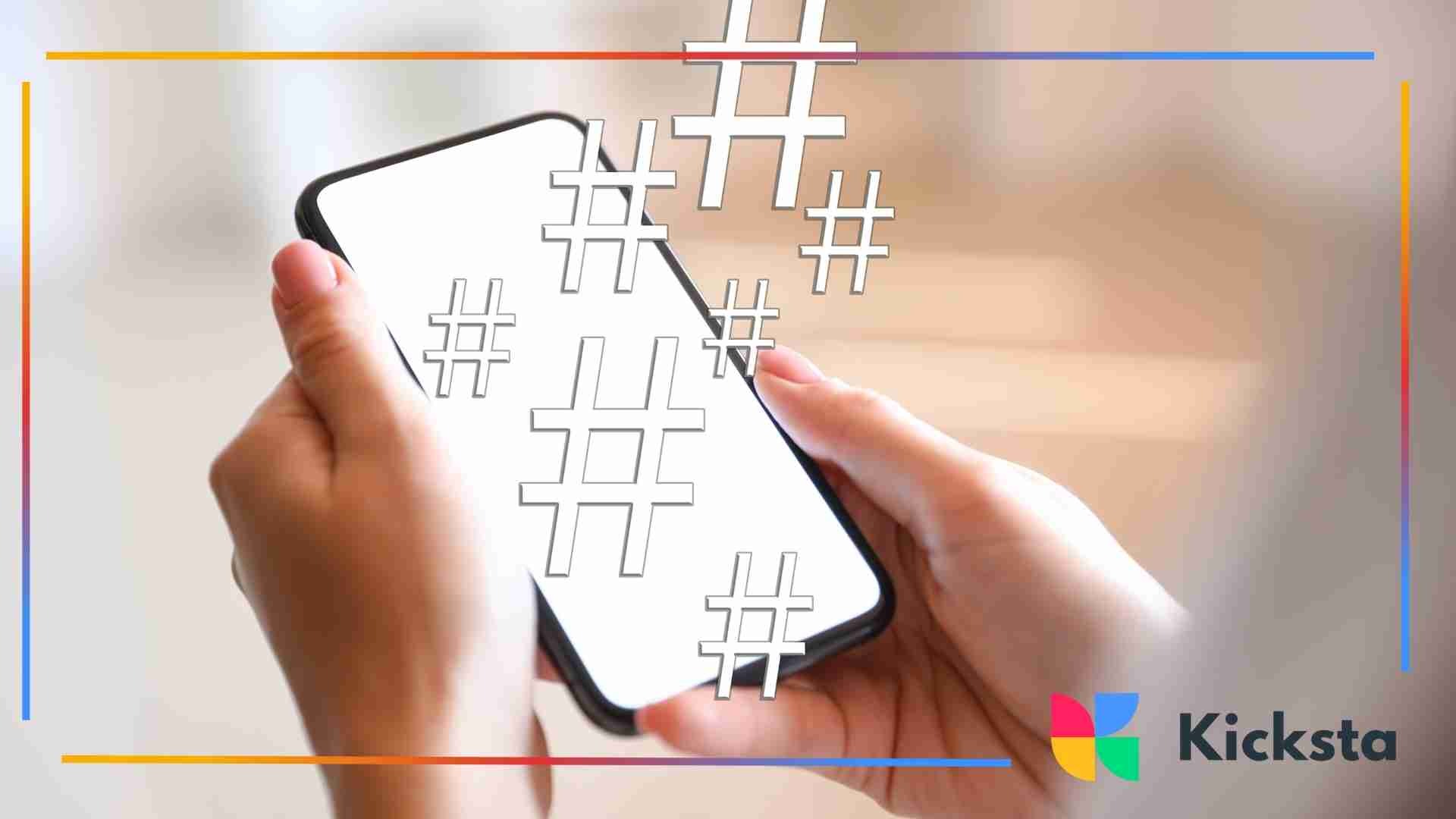 Smartphone held in both hands with hashtag symbols floating above the screen