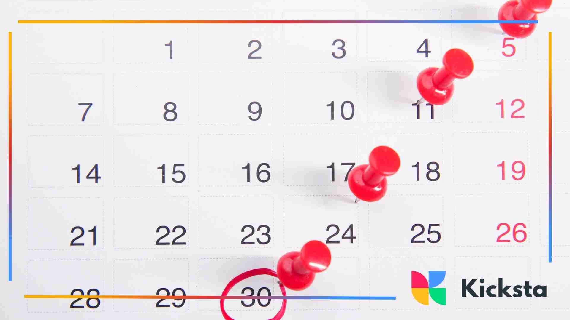 Monthly calendar page with red push pins marking specific dates