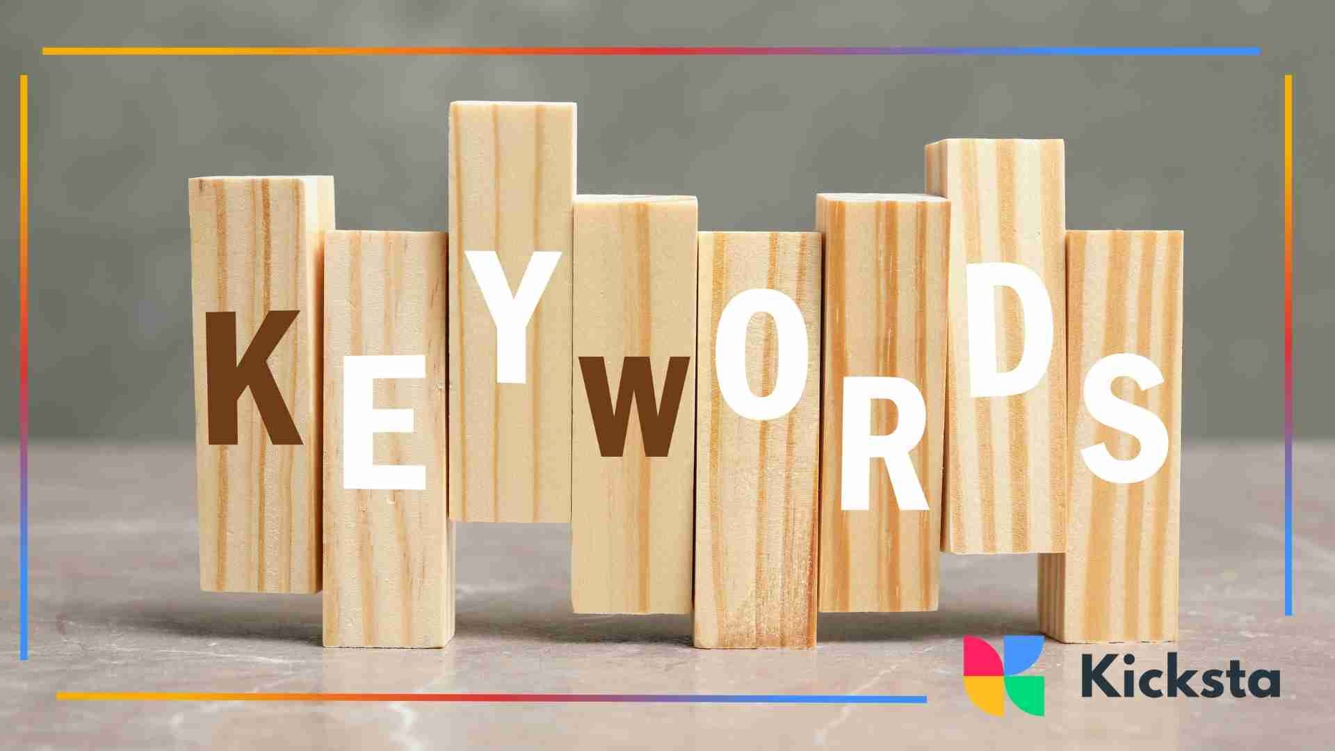 Wooden blocks arranged to spell the word “keywords” on a neutral surface.