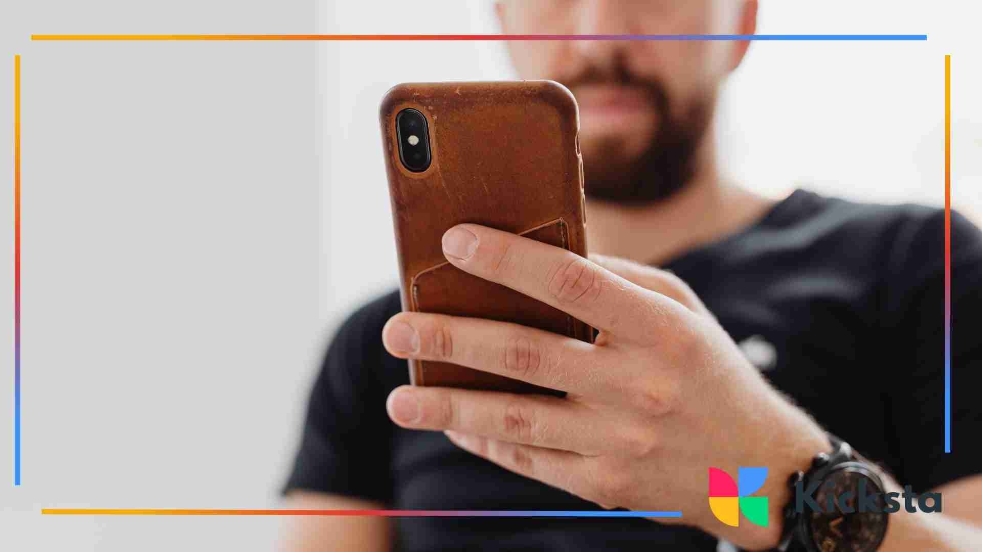 Close-up of a person holding a smartphone in one hand.