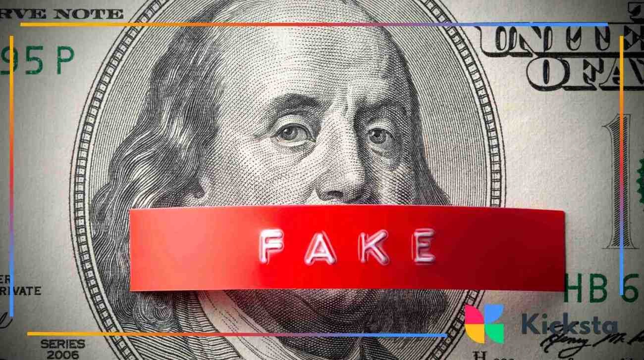 Close-up of a dollar bill with a red strip labeled “fake” covering the center.