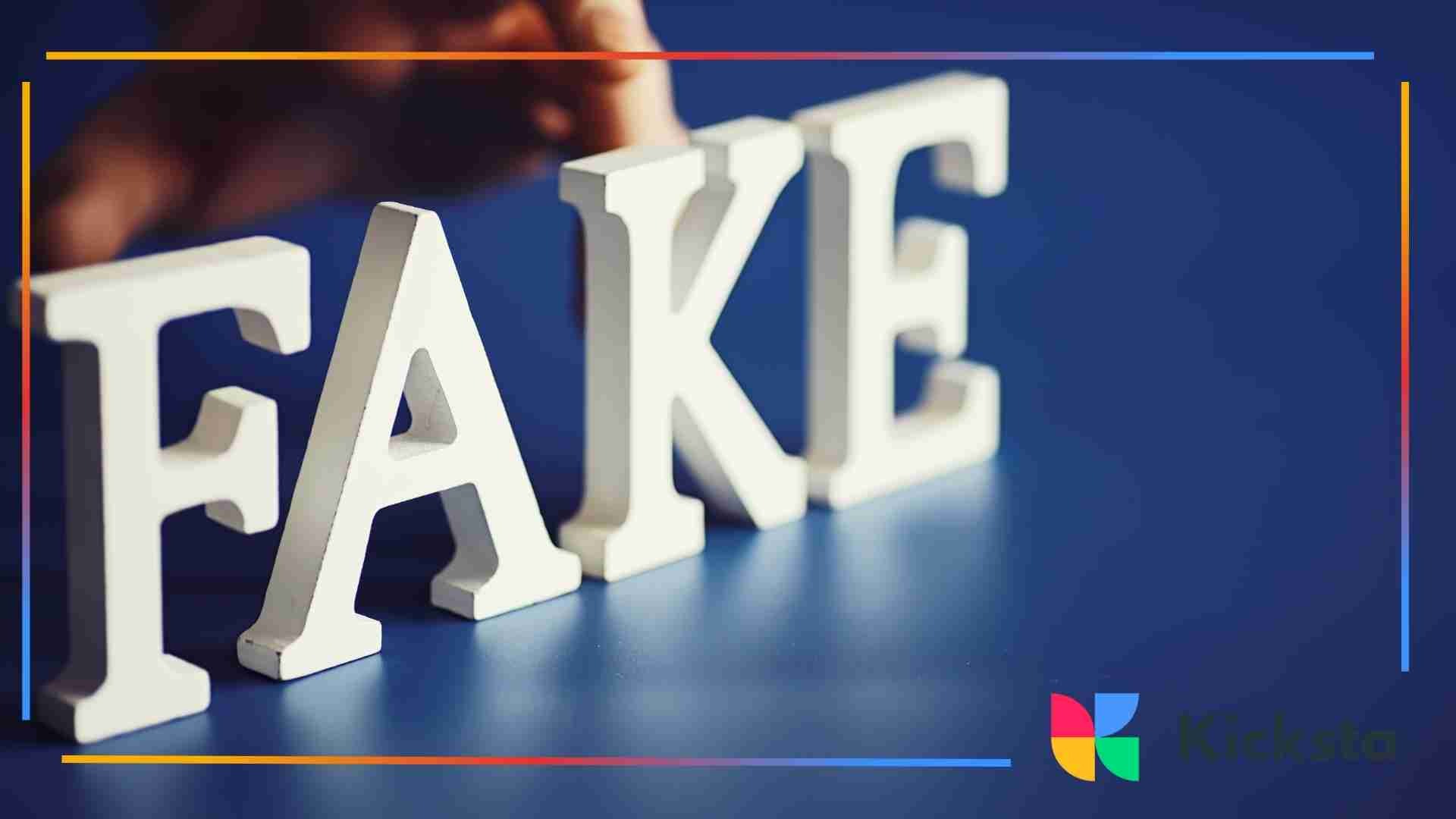 White letters spelling the word “fake” arranged on a blue surface.