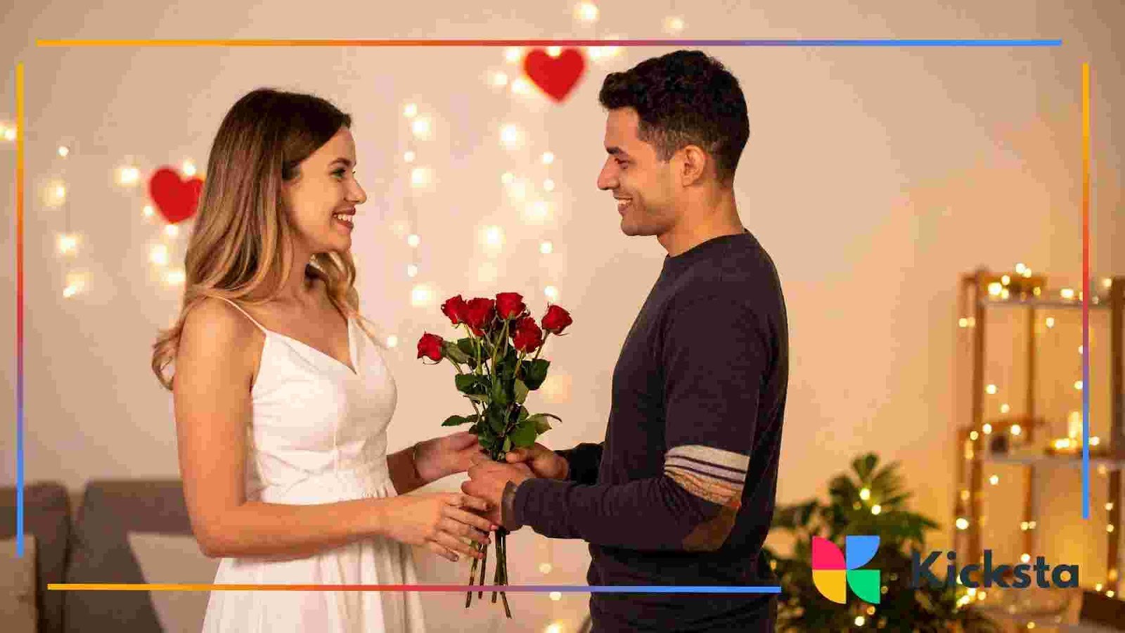 Person handing a bouquet of red roses to another person in a warmly lit room decorated with heart shapes.