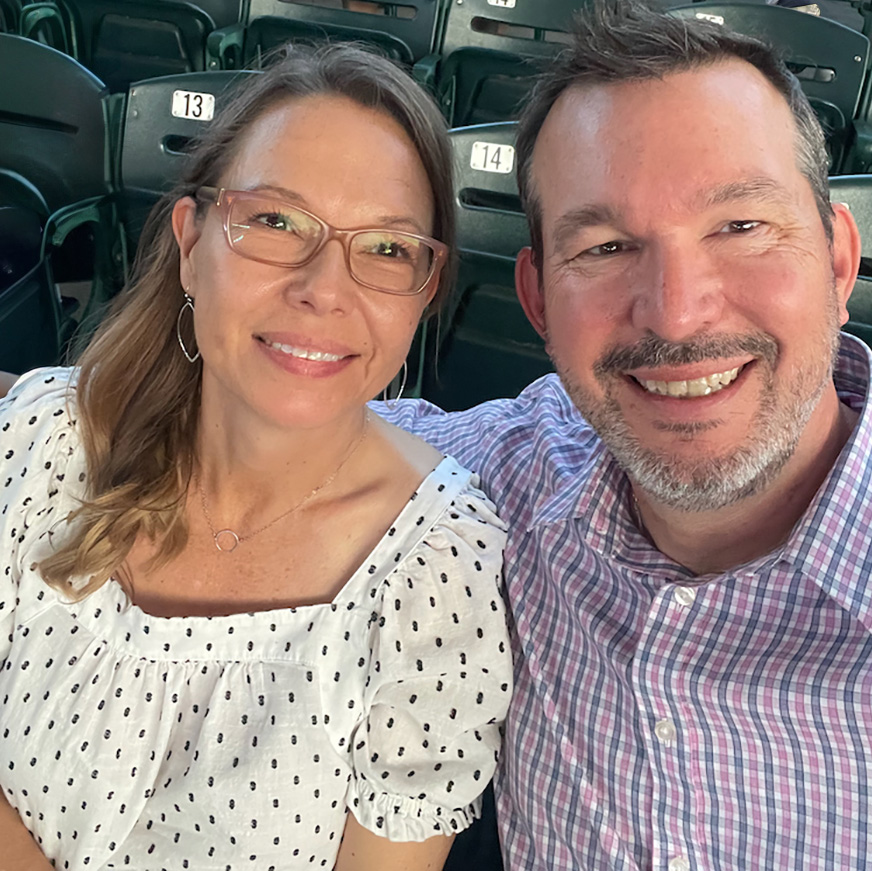 Chris and his wife Carrie sitting in the stands at a concert